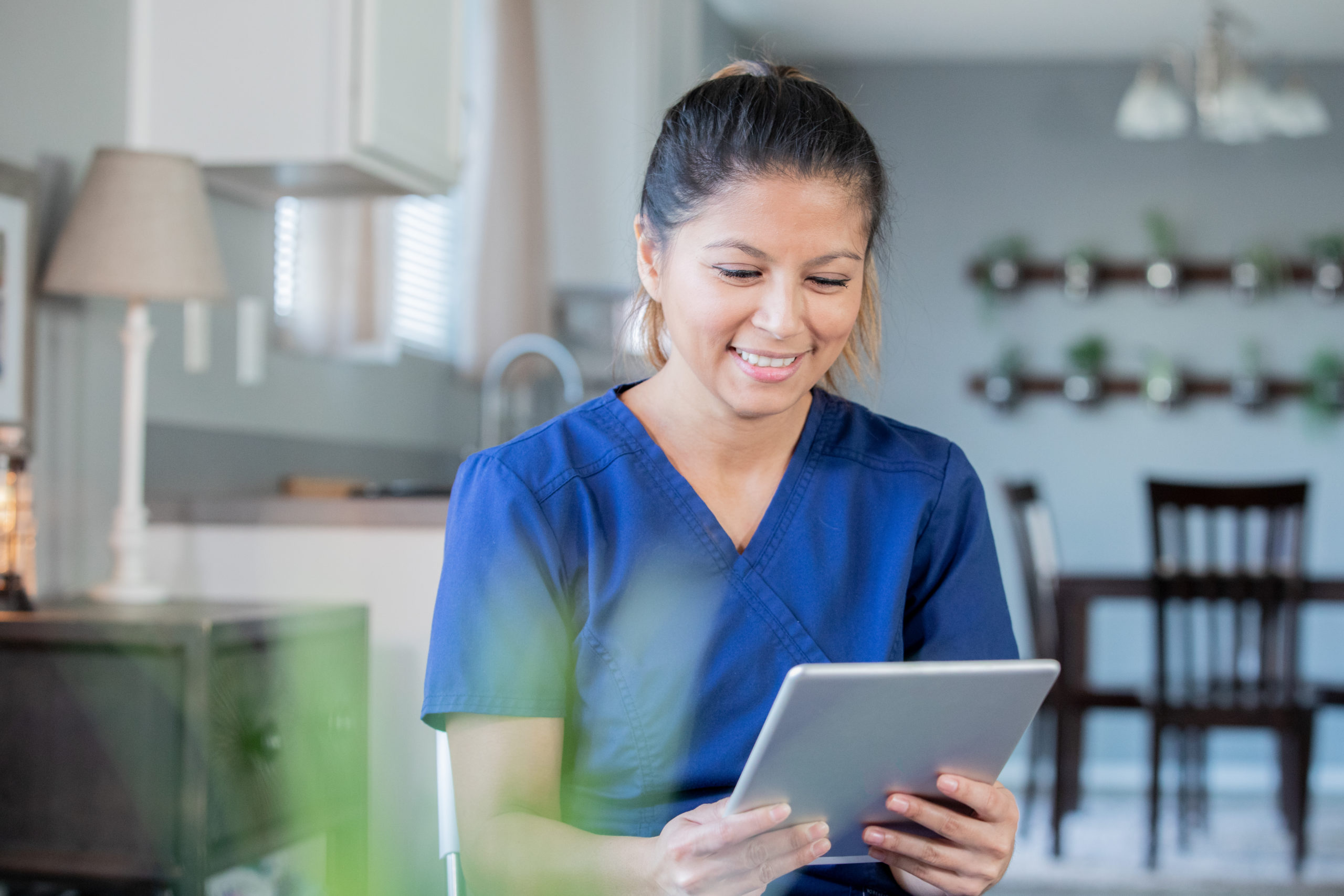 A nurse looking at a tablet