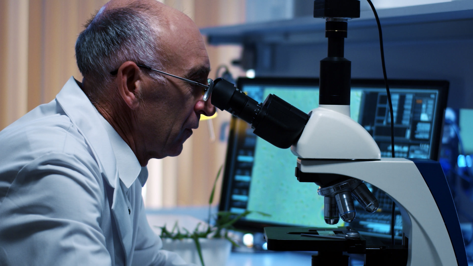 A man looking in a microscope