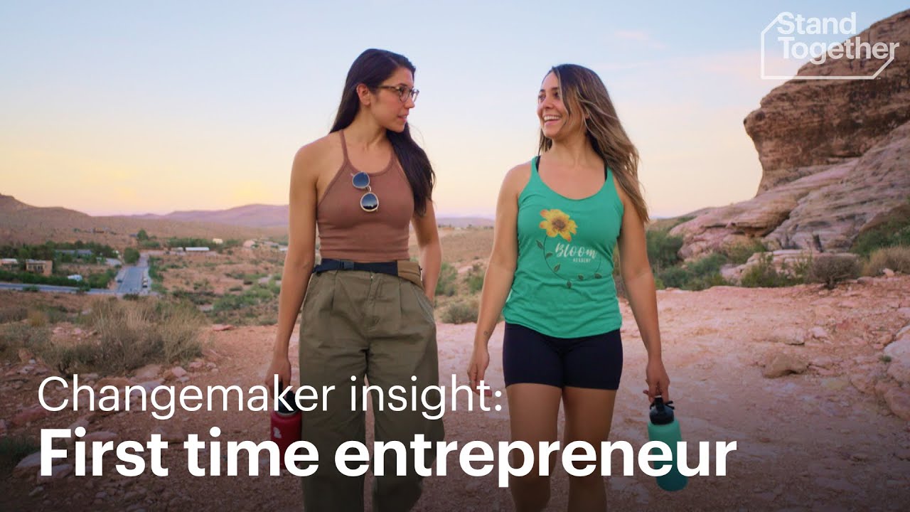 Two women standing outdoors with a desert landscape in the background, the text "Changemaker insight: First time entrepreneur" overlays the image.