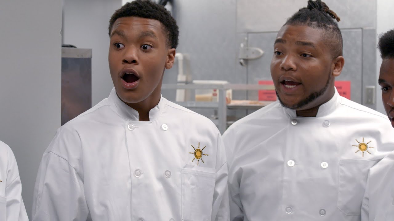 Two chefs in white uniforms expressing surprise.
