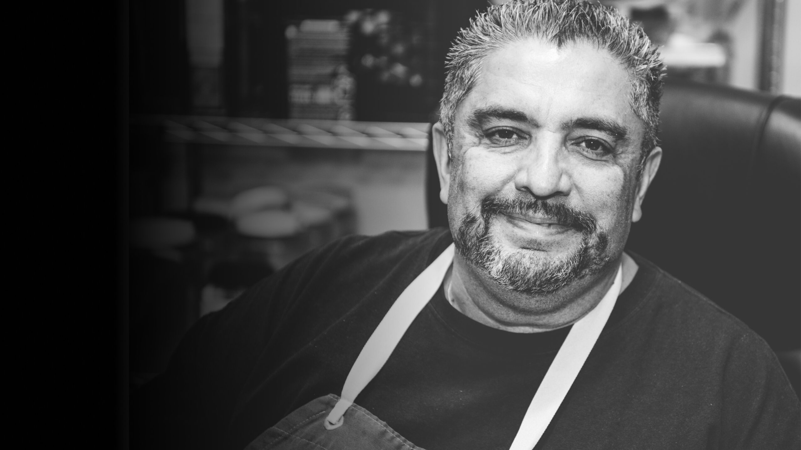 Black and white photo of Chef John Trejo Smiling